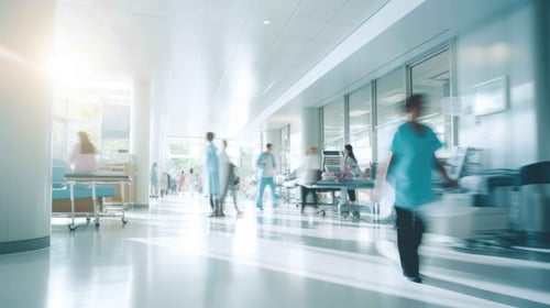 Blurry people walking through the corridors of a clinic