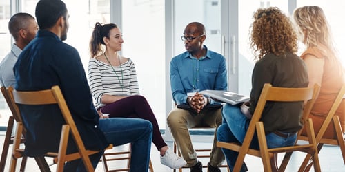 Psychiatrist giving a group session talking to patients