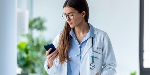 adult female doctor e-prescribing from her mobile phone