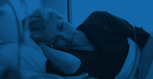 Woman lying in hospital bed awake